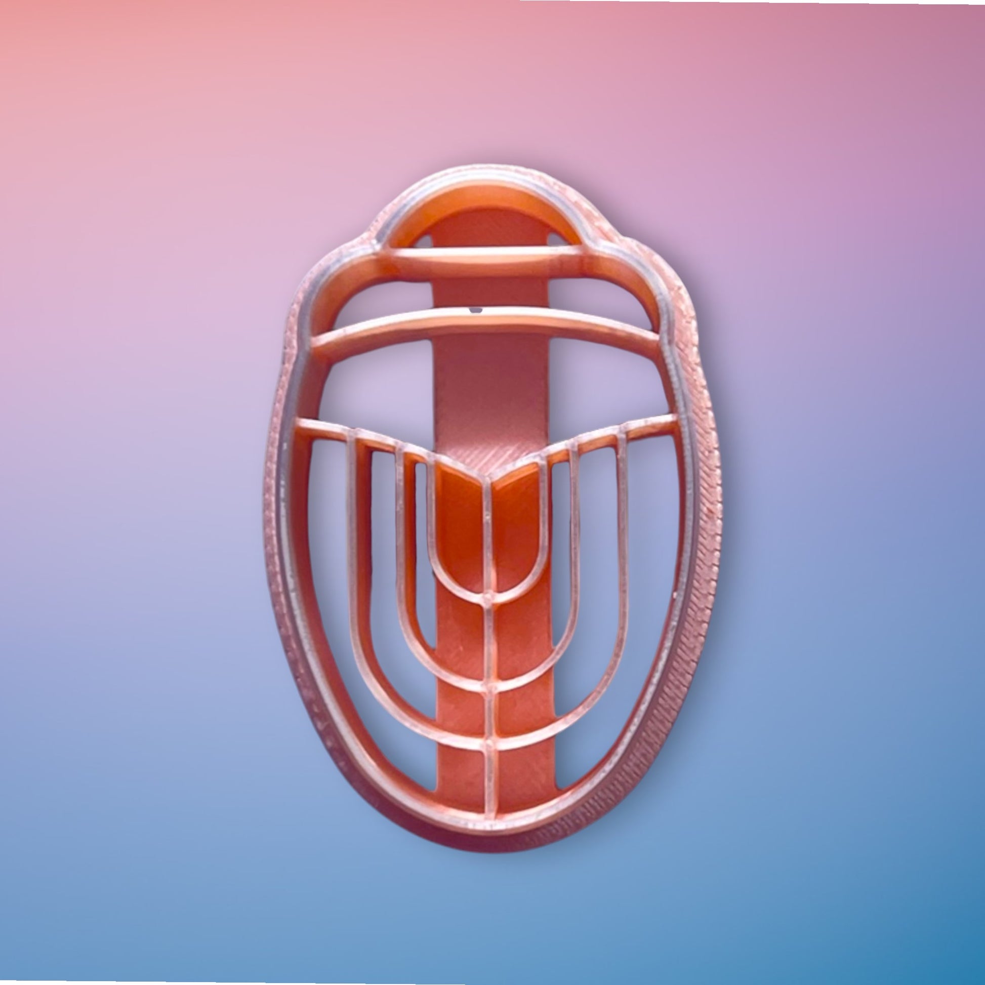 Art Deco Scarab polymer clay cutter with geometric embossed detailing on white background.