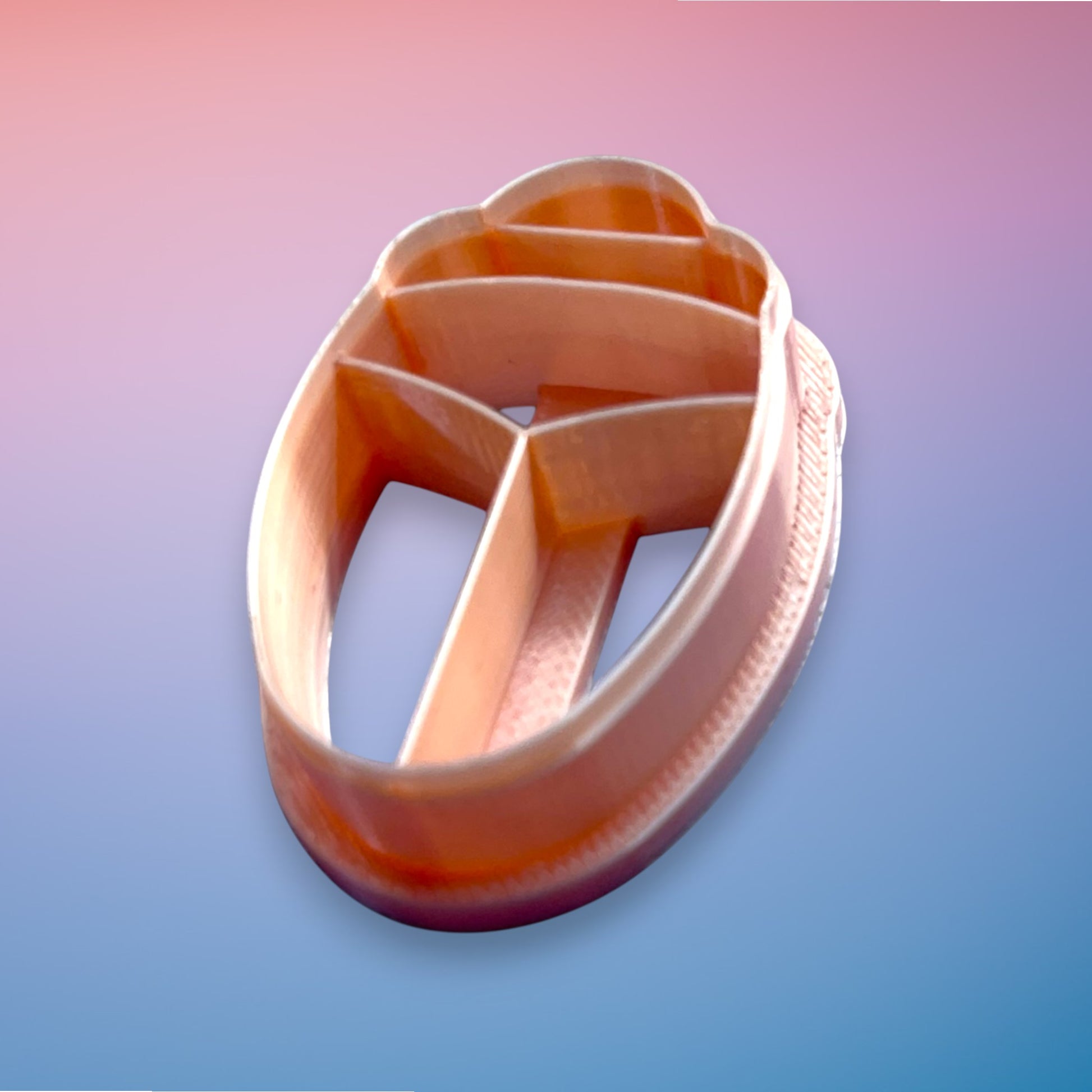 Beetle polymer clay cutter with smooth rounded body and segmented detail on white background.