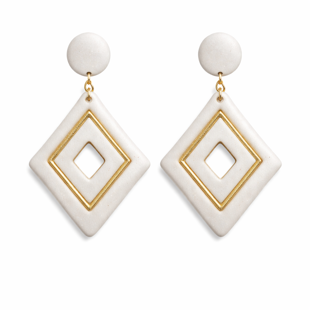 White diamond-shaped polymer clay drop earrings with gold trim detailing and a clean geometric style