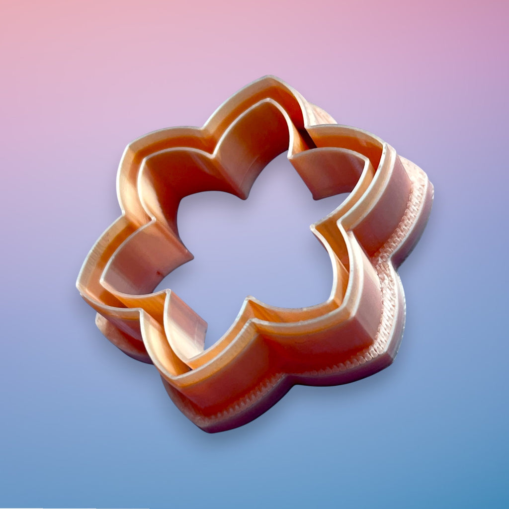 Daisy Bloom polymer clay cutter with rounded petal floral shape on white background.