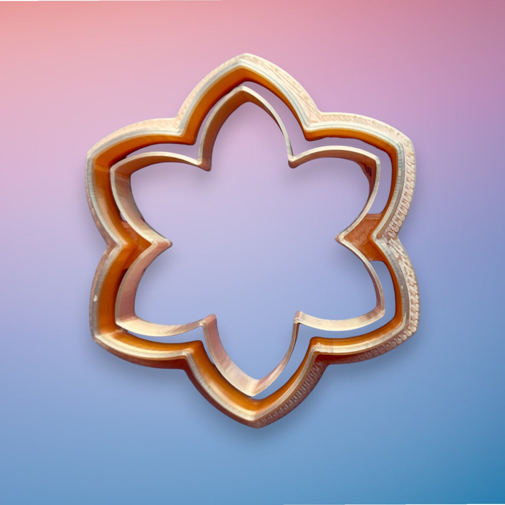 Daisy Bloom polymer clay cutter with rounded petal floral shape on white background.