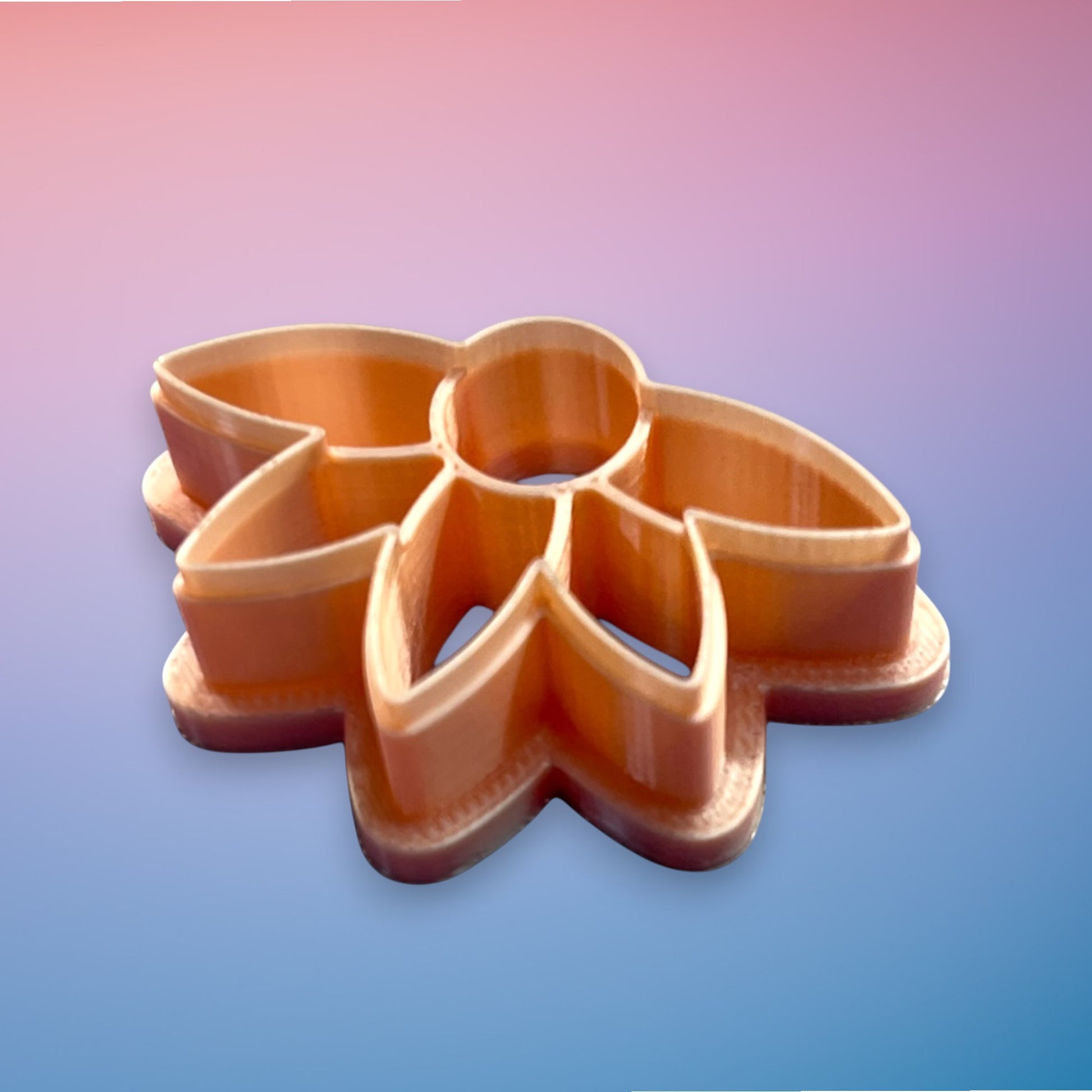 Daisy Dawn polymer clay cutter with flowing tapered petals and rounded center on white background.