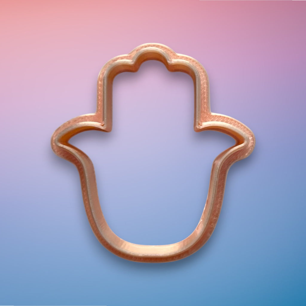 Hamsa Polymer Clay Cutter
Hamsa polymer clay cutter with symmetrical protective hand silhouette on white background.