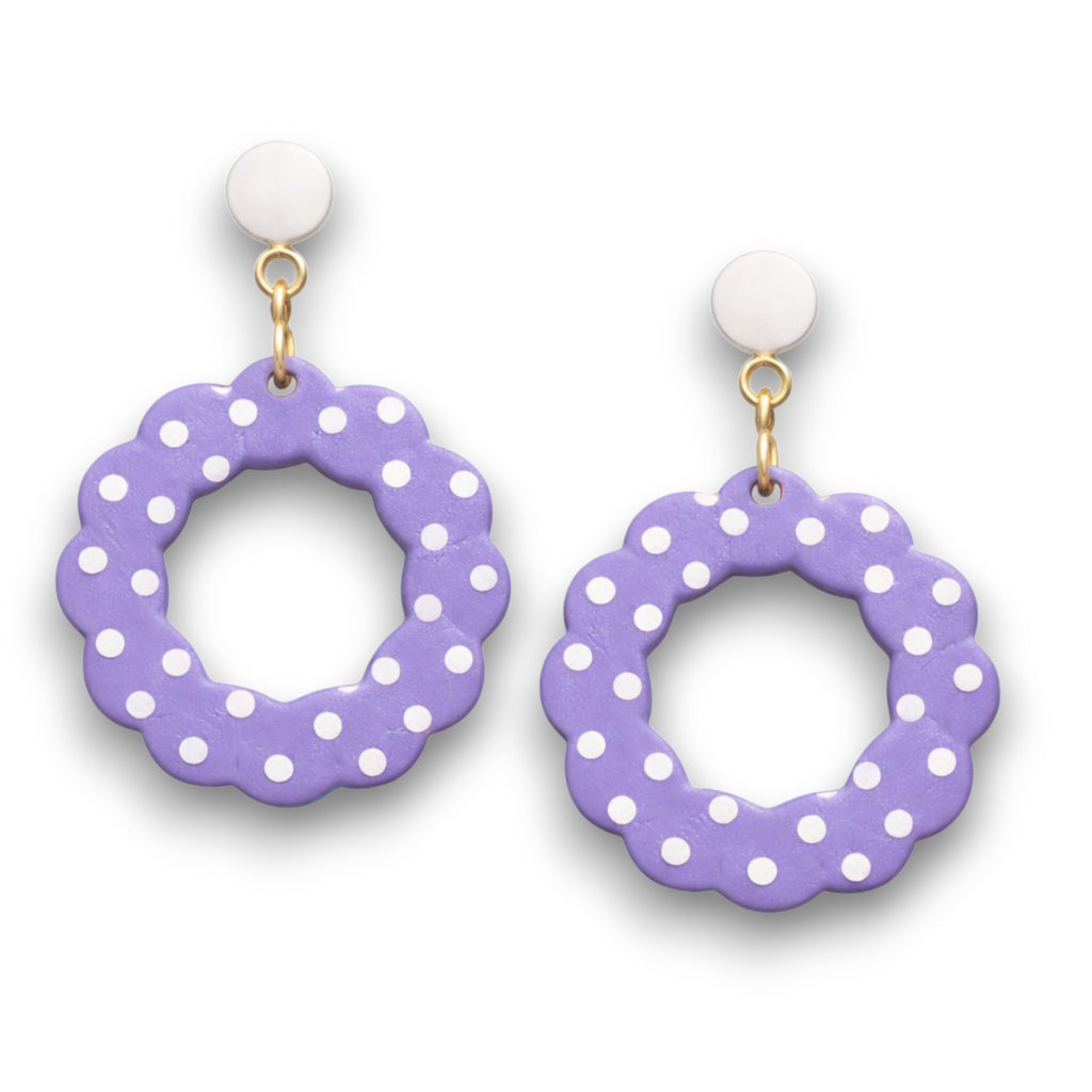 Purple earrings with white polka dots on a white background