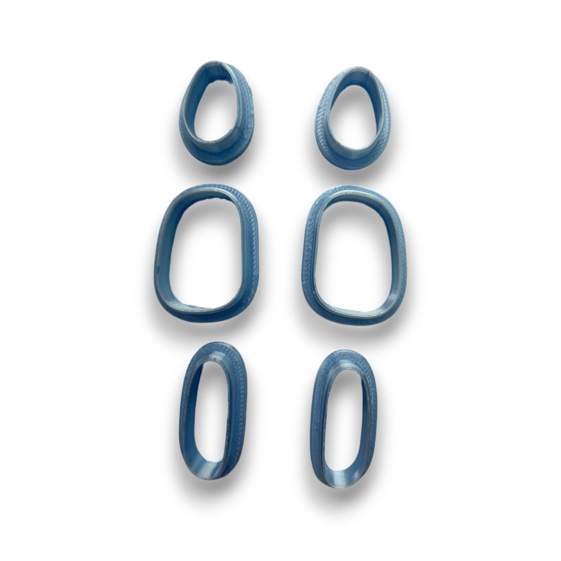 Pebble Stack polymer clay cutters set of 6 featuring mirrored organic pebble shapes on white background