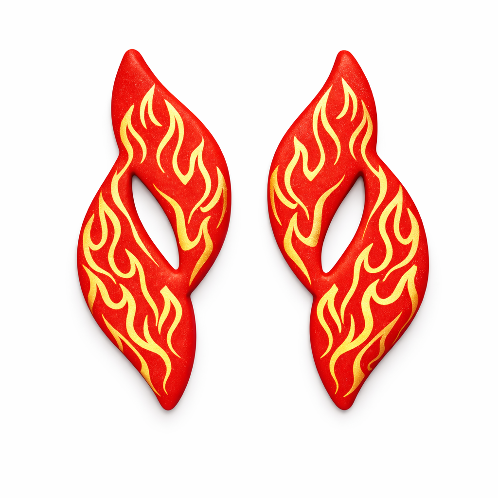 Flame Drop polymer clay cutters with clay cutouts in red, with gold flames on white flat lay background