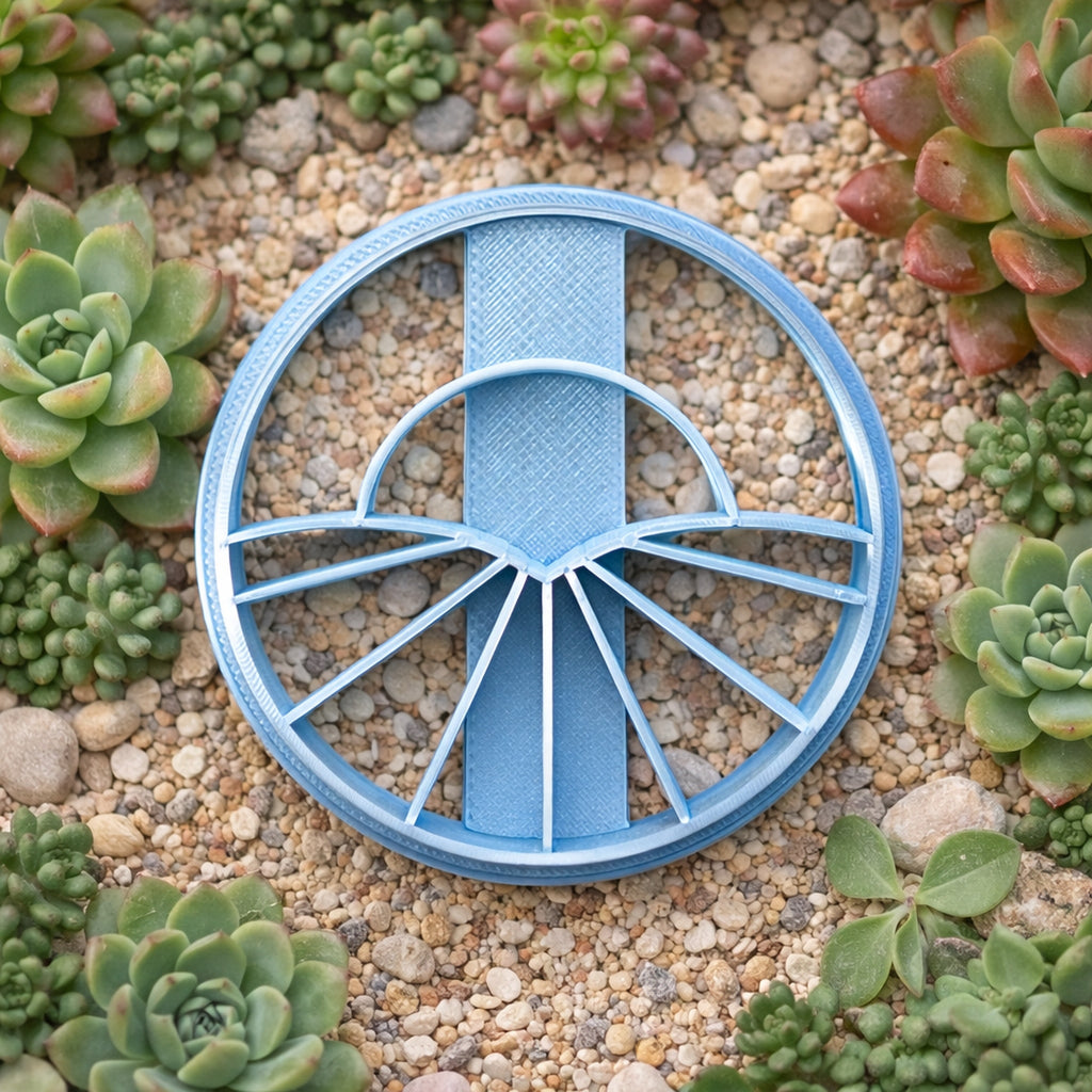 Round polymer clay cutter with rising sun and radiating ray design, geometric art deco style shape