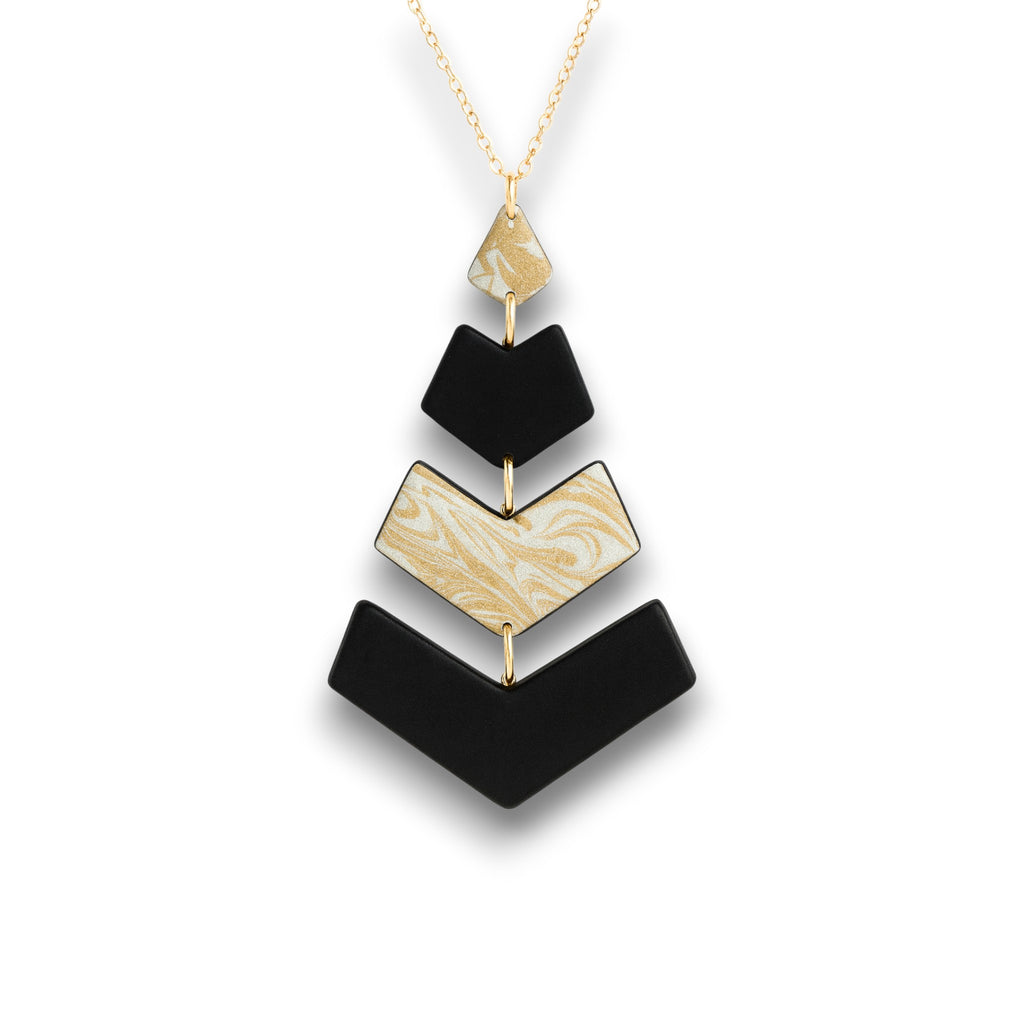 Chevron polymer clay pendant in black and ivory with a gold swirl accent and a modern handcrafted design