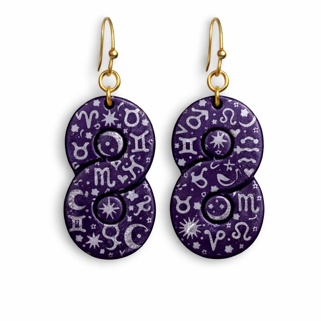 Dark purple polymer clay earrings made with Twist cutter featuring silver astrology and astronomy symbols