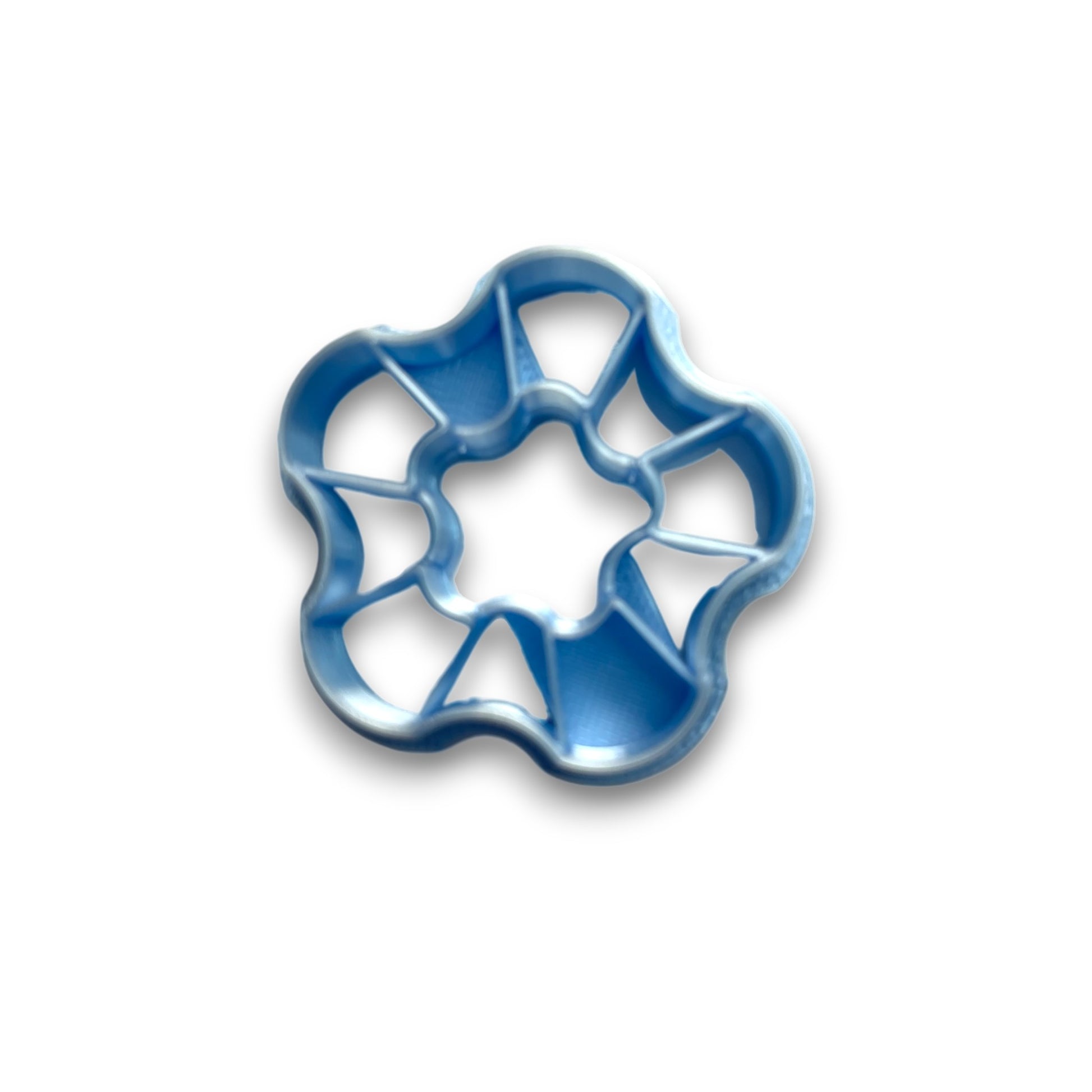 Wave donut polymer clay cutter with rounded petal edges and built-in embossing for soft, modern clay designs